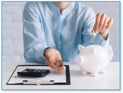 Woman putting money into piggy bank