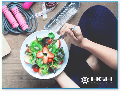 Person eating salad with weight nearby