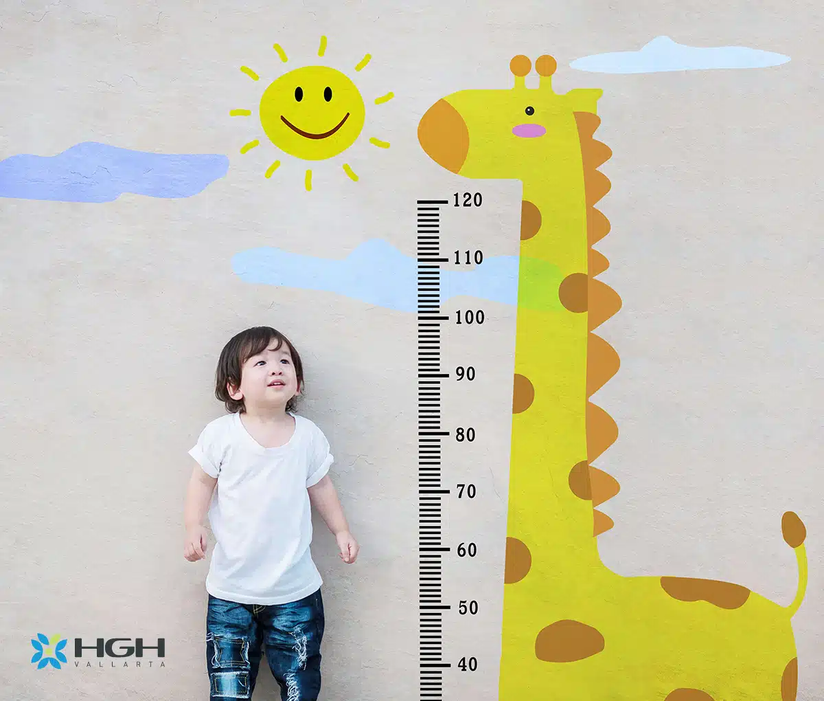 small child standing next to a wall with a giraffe and a growth chart