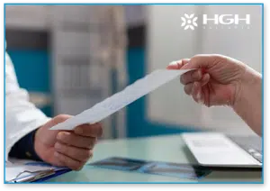 endocrinologist handing HGH prescription to patient